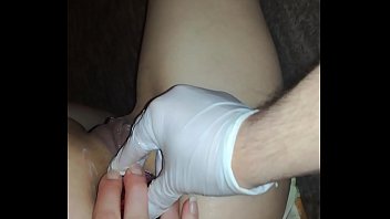 Partner in gloves fisting wide vagina of restless horny beauty